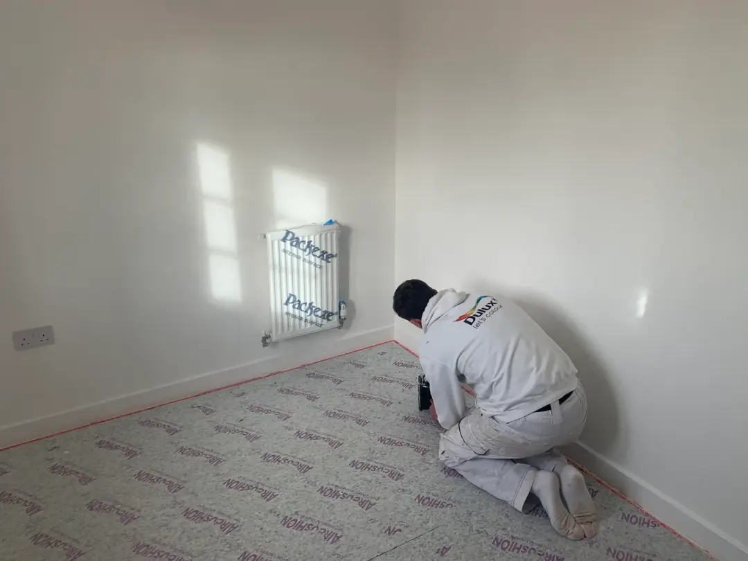 Jan Dawson’s Google review photo showing interior painting with flooring and radiator protected